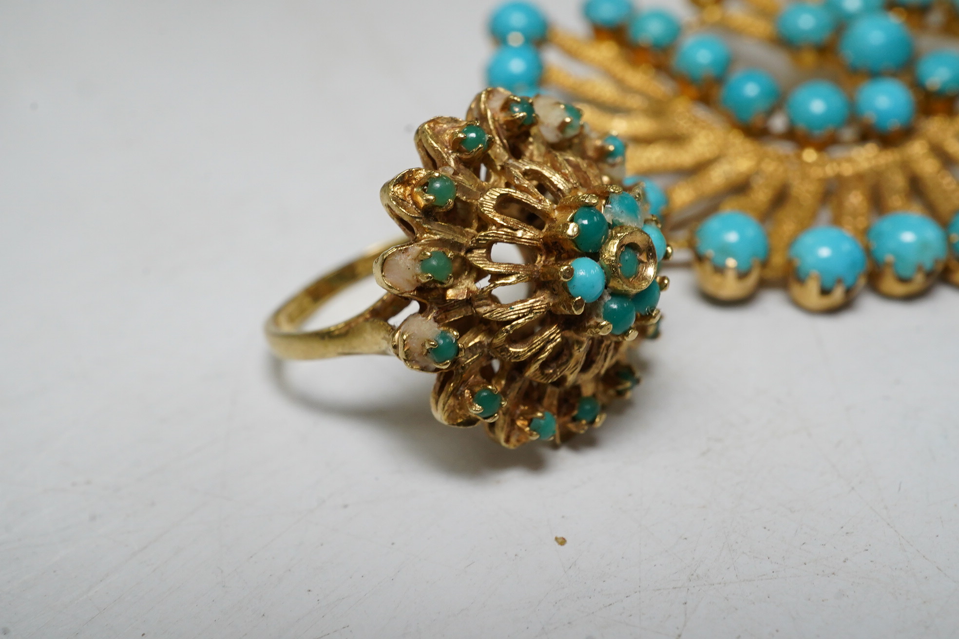 An 18ct gold and turquoise dress ring, gross 7.3 grams, and a turquoise set brooch stamped 750, gross 10.5 grams Condition - fair.